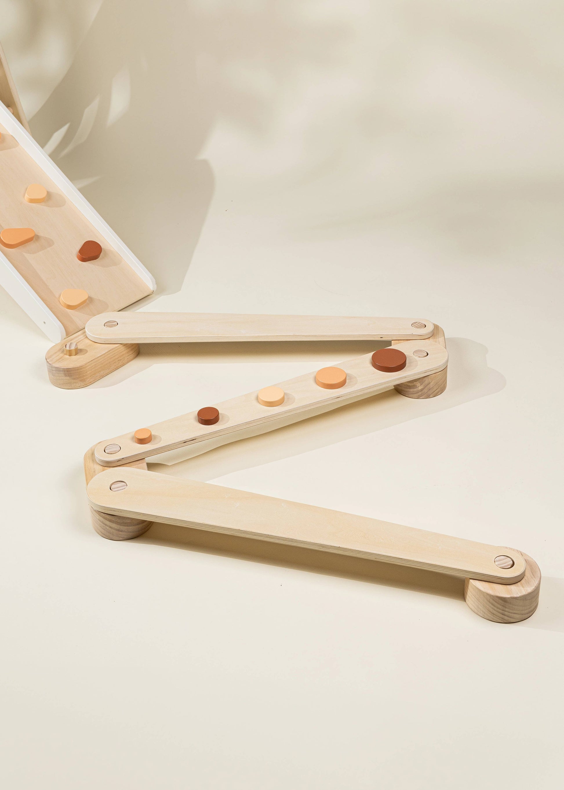 Wooden balancing toy with colorful buttons and legs