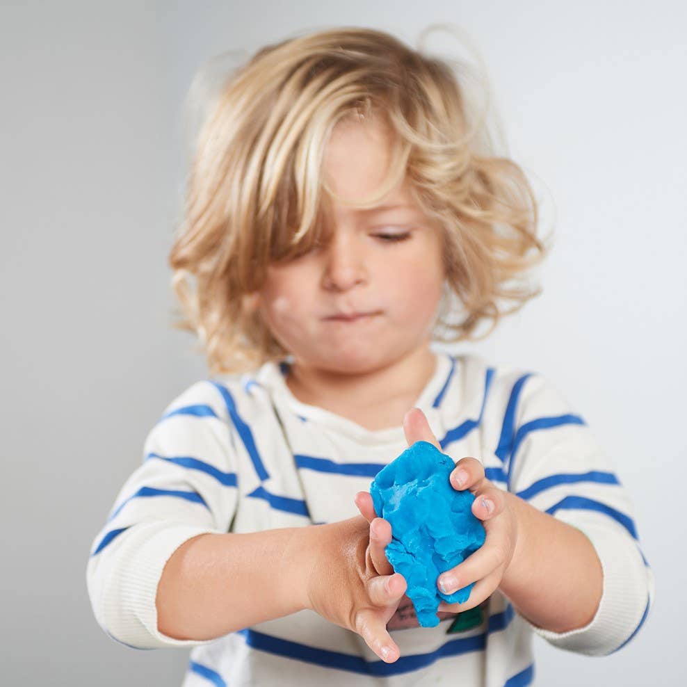 Kid playing with Mila and Moo's non toxic blue playdough